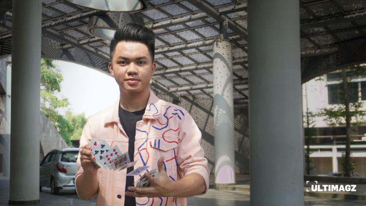 Aaron Nathanael mahasiswa Komunikasi Strategis 2022 UMN sedang memainkan trik kartu. (ULTIMAGZ/Bryant Alexander)