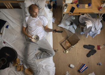 Ilustrasi lelaki di atas kasur sedang bed rotting.